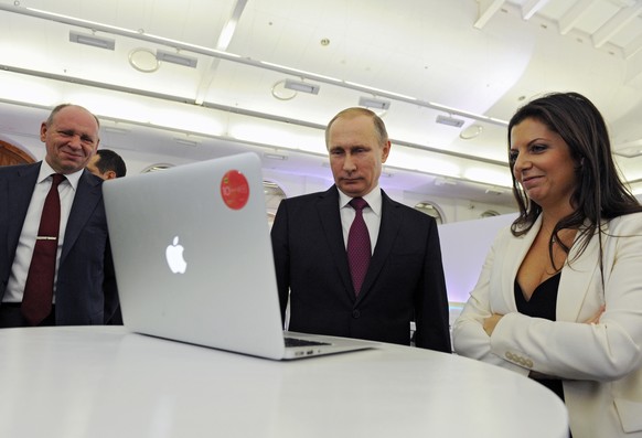 Russian President Vladimir Putin and Editor-in-chief of RT (Russia Today) 24-hour English-language TV news channel, Margarita Simonyan, attend an exhibition marking RT&#039;s 10th anniversary in Mosco ...