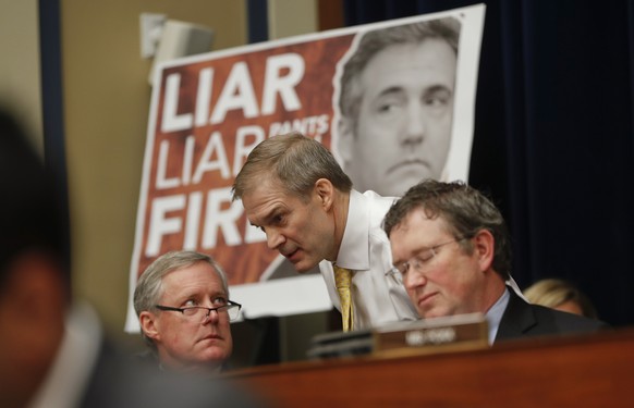 Rep. Jim Jordan, R-Ohio, center, ranking member of the Committee on Oversight and Reform talks with Rep. Mark Meadows, R-N.C., left, and Rep. Thomas Massie, R-Ky., right, during testimony by Michael C ...