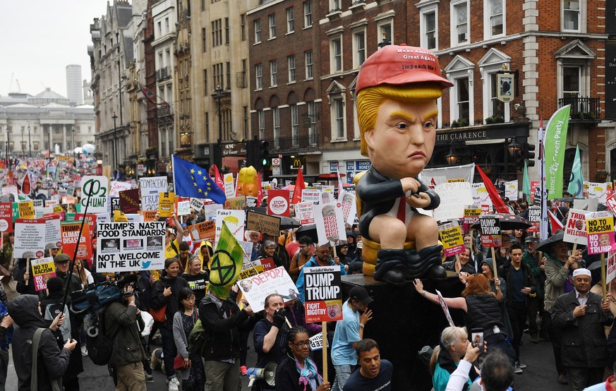 epa07624441 People march down Whitehall during an anti-Trump protest against US President Donald J. Trump State visit to the UK at Trafalgar Square in London, Britain, 04 June 2019. US President Trump ...