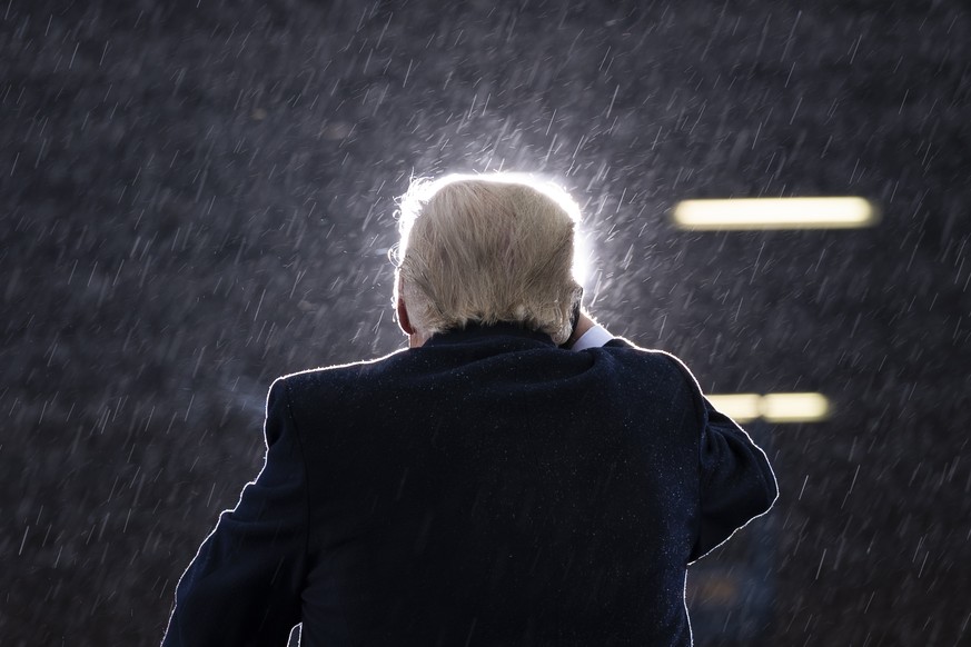 President Donald Trump speaks in the rain during a campaign rally at Capital Region International Airport in Lansing Mich., on Oct. 27, 2020. (AP Photo/Evan Vucci)
Donald Trump