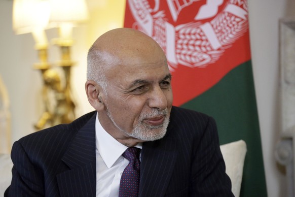 FILE - In this June 17, 2019 file photo, Afghanistan&#039;s President Ashraf Ghani speaks with British Prime Minister Theresa May at the start of their meeting inside 10 Downing Street in London. Afgh ...