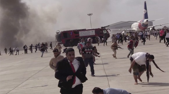 People run following an explosion at the airport in Aden, Yemen, shortly after a plane carrying the newly formed Cabinet landed on Wednesday, Dec. 30, 2020. No one on board the government plane was hu ...