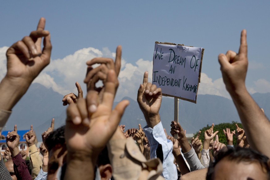 FILE - In this Friday, Aug. 23, 2019, file photo, Kashmiri men shout freedom slogans during a protest against New Delhi&#039;s tightened grip on the disputed region, after Friday prayers on the outski ...