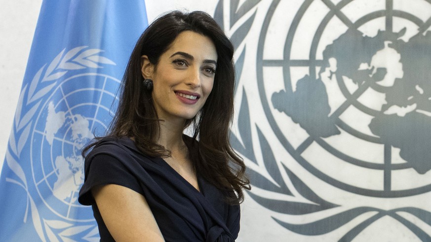 FILE - In this Friday, March 10, 2017, file photo, human rights lawyer Amal Clooney poses for a photo at the United Nations headquarters. Clooney plans to represent two investigative reporters on tria ...