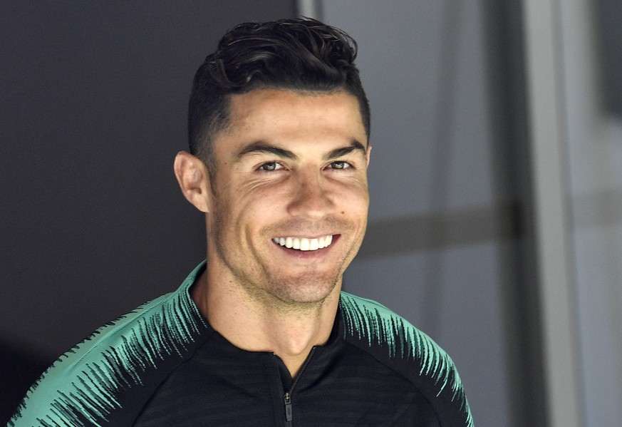 FILE - In this June 8, 2019, file photo, Portugal&#039;s Cristiano Ronaldo smiles when he arrives to a training session at the Bessa stadium in Porto, Portugal. Soccer star Cristiano Ronaldo wonÄôt f ...