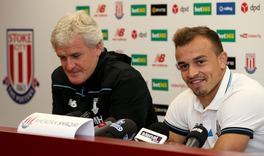 Stoke City&#039;s new signing Xherdan Shaqiri, right, attends a press conference with manager Mark Hughes at the Britannia Stadium, Stoke-on-Trent England Thursday Aug. 13, 2015. Stoke has completed t ...