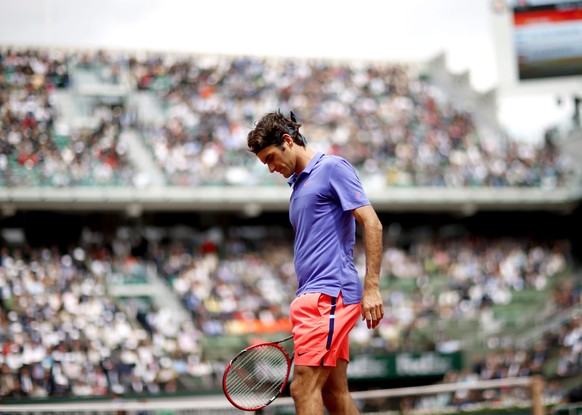 FILE - Roger Federer of Switzerland in action against Damir Dzumhur of Bosnia-Herzegovina during their third round match for the French Open tennis tournament at Roland Garros in Paris, France, 29 May ...
