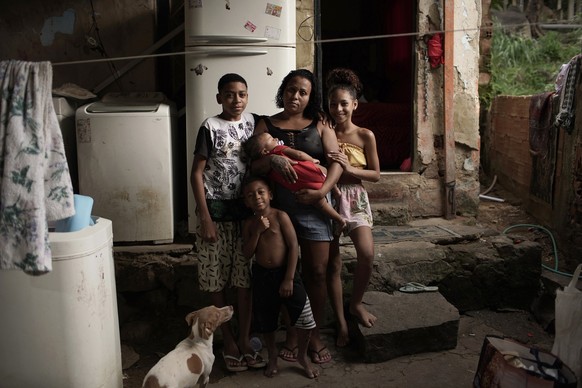 Manicurist Leticia Machado, 31, poses for a photo with 4 of her 7 children at her home, during the new coronavirus pandemic in Turano favela, Rio de Janeiro, Brazil, Wednesday, April 15, 2020. Machado ...