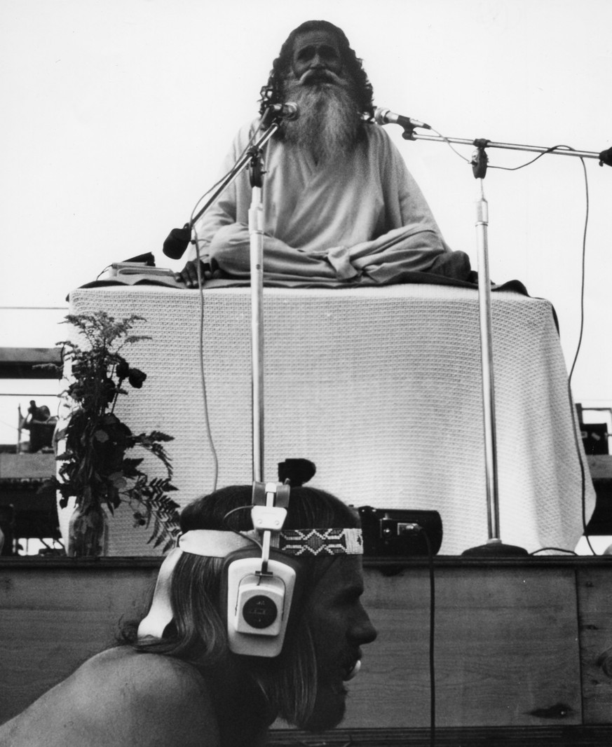 SWAMI SATCHIDANANDA OPENED THE WOODSTOCK MUSIC FESTIVAL BY SHARING A PRAYER OF PEACE AND LOVE
at the Woodstock Music Festival on August 16, 1969 in Woodstock, New York. (Photo by Warner Bros/Michael O ...