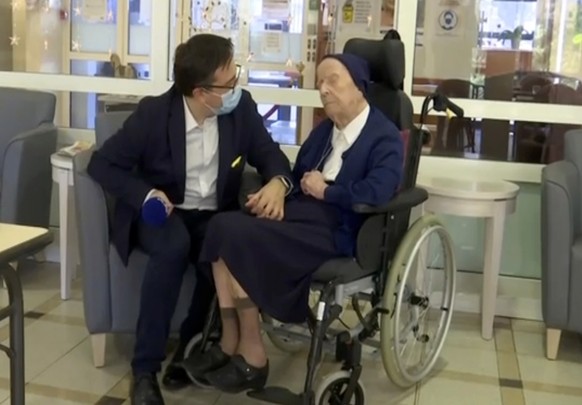 In this image made from BFM TV video, Sister Andre, born Lucile Randon, is interviewed by David Tavella, Communications Manager for the Sainte Catherine Laboure Nursing Home in Toulon, France, Tuesday ...