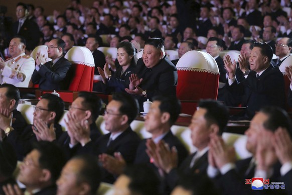 In this photo provided by the North Korean government, North Korean leader Kim Jong Un, center, and his wife Ri Sol Ju watch a performance marking the birth anniversary of former leader Kim Jong Il, i ...