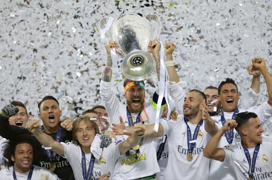FILE - In this May 28, 2016 fiel photo, Real Madrid&#039;s Sergio Ramos raises the trophy after the Champions League final soccer against Atletico Madrid at the San Siro stadium in Milan, Italy. An em ...