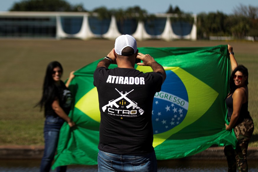 epa08537254 Supporters of Brazilian President Jair Bolsonaro, take a photo in front of the Alvorada Palace in Brasilia, Brazil 09 July 2020. Bolsonaro is working from his official residence in Brasili ...