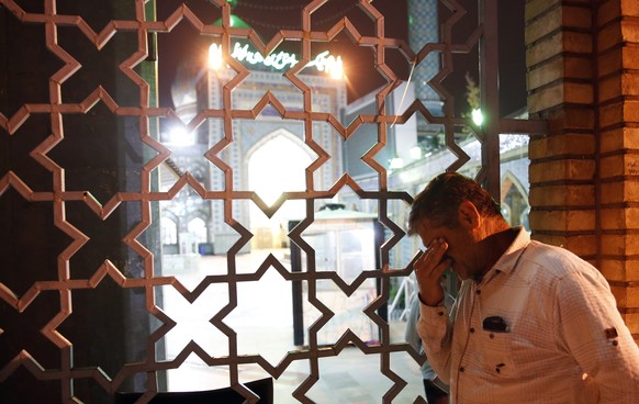 epa08382998 An Iranian man prays outside of the Saleh Shrine on the eve of the holy month of Ramadan, in Tehran, Iran, 24 April 2020. Media reported that as Ramadan starts from 25 April in Iran, holy  ...