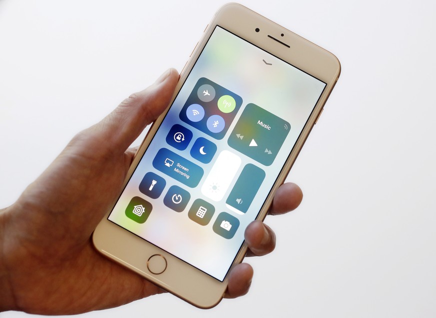 In this Sept. 15, 2017, photo, the iOS 11 control center is displayed on the iPhone 8 Plus in New York. The control center offers easy access to the flashlight and other tools with a swipe up from the ...