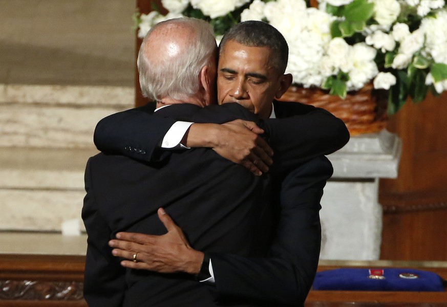 ADVANCE FOR PUBLICATION ON SUNDAY, AUG. 18, AND THEREAFTER - FILE - In this June 6, 2015, file photo, then=President Barack Obama hugs then-Vice President Joe Biden during funeral services for Biden&# ...