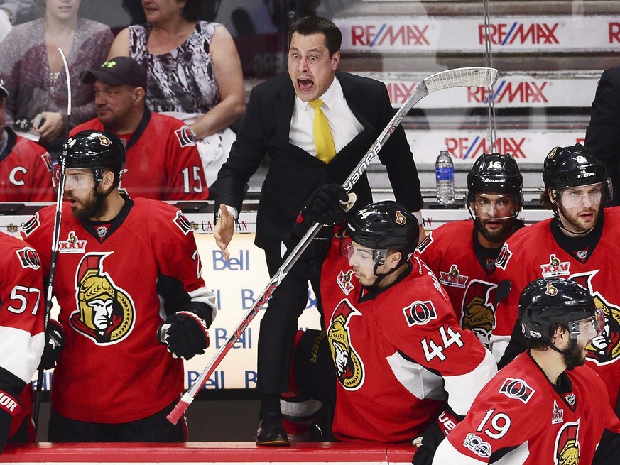 Ottawa Senators coach Guy Boucher, center, and players react to a penalty call during the first period in Game 1 of the team&#039;s NHL hockey second-round playoff series against the New York Rangers, ...