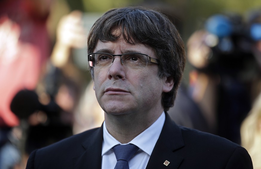 Catalan regional President Carles Puigdemont attends a ceremony commemorating the 77th anniversary of the death of Catalan leader Lluis Companys at the Montjuic Cemetery in Barcelona, Spain, Sunday, O ...
