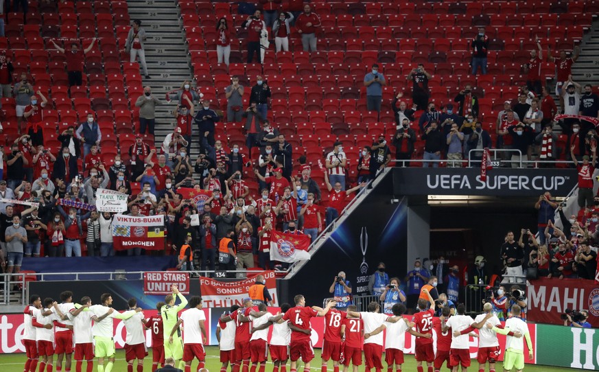 Bayern players celebrate in front of their fans after the UEFA Super Cup soccer match between Bayern Munich and Sevilla at the Puskas Arena in Budapest, Hungary, Thursday, Sept. 24, 2020. Bayern won t ...