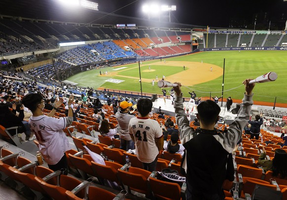 epa08739966 Fans keep social distance in the stands while watching a Korea Baseball Organization (KBO) regular season game between the Hanwha Eagles and the Doosan Bears at Jamsil Stadium in Seoul, So ...