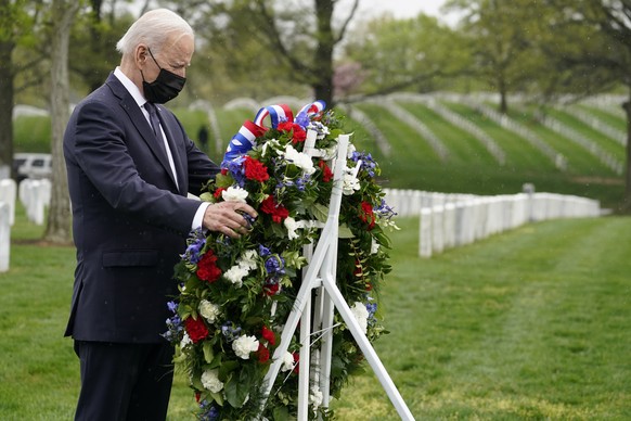 President Joe Biden lays a wreath as he visits Section 60 of Arlington National Cemetery in Arlington, Va., on Wednesday, April 14, 2021. Biden announced the withdrawal of the remainder of U.S. troops ...