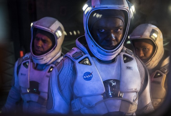 This image released by Netflix shows John Ortiz, from left, David Oyelowo and Gugu Mbatha-Raw in a scene from &quot;The Cloverfield Paradox.&quot; (Scott Garfield/Netflix via AP)