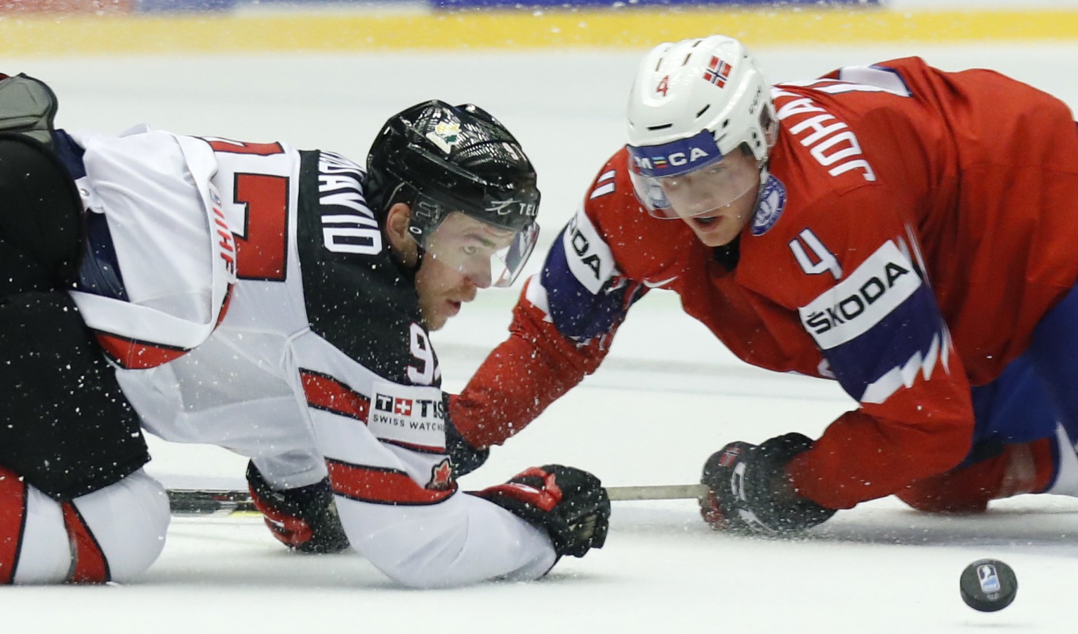 Canada&#039;s Connor McDavid, left, challenges for the puck with Norway&#039;s Johannes Johannesen, right, during the Ice Hockey World Championships group B match between Norway and Canada at the Jysk ...