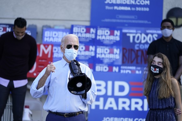 Democratic presidential candidate former Vice President Joe Biden, accompanied by his granddaughter Natalie Biden, speaks to people outside a campaign victory center, Thursday, Oct. 29, 2020, in Fort  ...