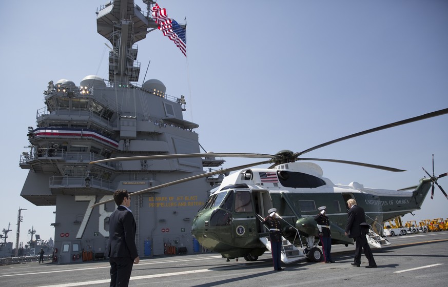 President Donald Trump walks to board Marine One on the flight deck of the USS Gerald R. Ford (CVN 78) at Naval Station Norfolk, Va., Saturday, July, 22, 2017, after the commissioning ceremony of the  ...
