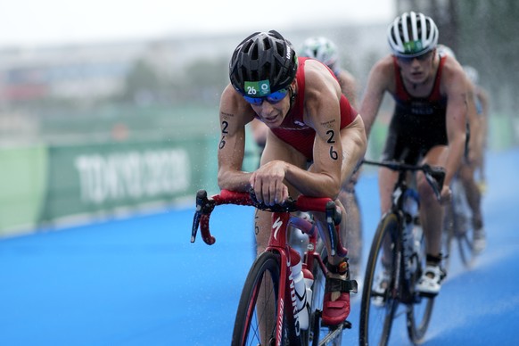 Nicola Spirig of Switzerland (26) competes on the bike leg during the women&#039;s individual triathlon competition at the 2020 Summer Olympics, Tuesday, July 27, 2021, in Tokyo, Japan. (AP Photo/Davi ...