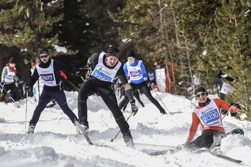 Participants tumble at the Stazerwald near St. Moritz, during the annual Engadin cross-country skiing marathon from Maloja to S-Chanf in south Eastern Switzerland, Sunday, March 13, 2016. Thousands of ...