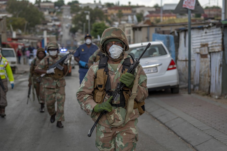 South African National Defense Forces patrol the densely populated Alexandra township east of Johannesburg Friday, March 27, 2020. South Africa went into a nationwide lockdown for 21 days in an effort ...