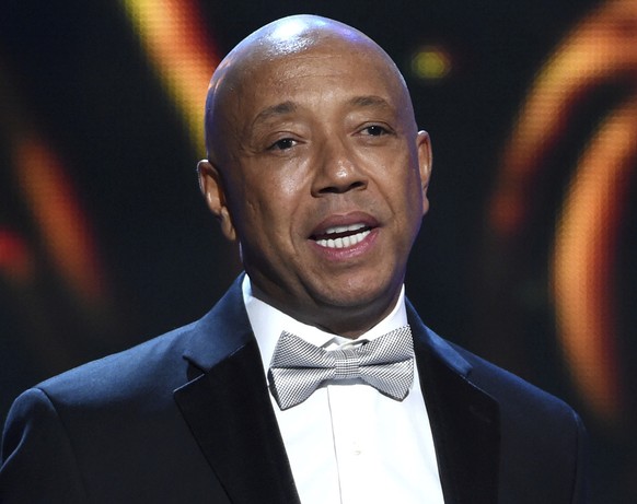 FILE - In this Feb. 6, 2015, file photo, hip-hop mogul Russell Simmons presents the Vanguard Award on stage at the 46th NAACP Image Awards in Pasadena, Calif. In a report published Sunday, Nov. 19, 20 ...