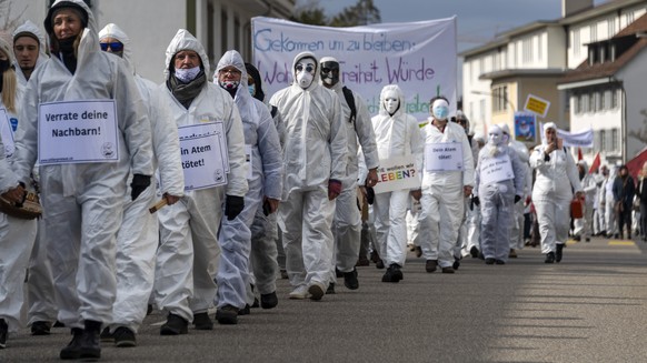 Anhaenger des Vereins Stiller Protest bei einer Demonstration gegen die Massnahmen zur Eindaemmung des Coronavirus in Liestal, am Samstag, 20. Maerz 2021. (KEYSTONE/Georgios Kefalas)