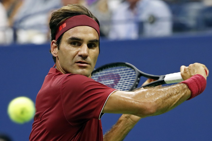 Roger Federer, of Switzerland, returns a shot to Yoshihito Nishioka, of Japan, during the first round of the U.S. Open tennis tournament, Tuesday, Aug. 28, 2018, in New York. (AP Photo/Adam Hunger)