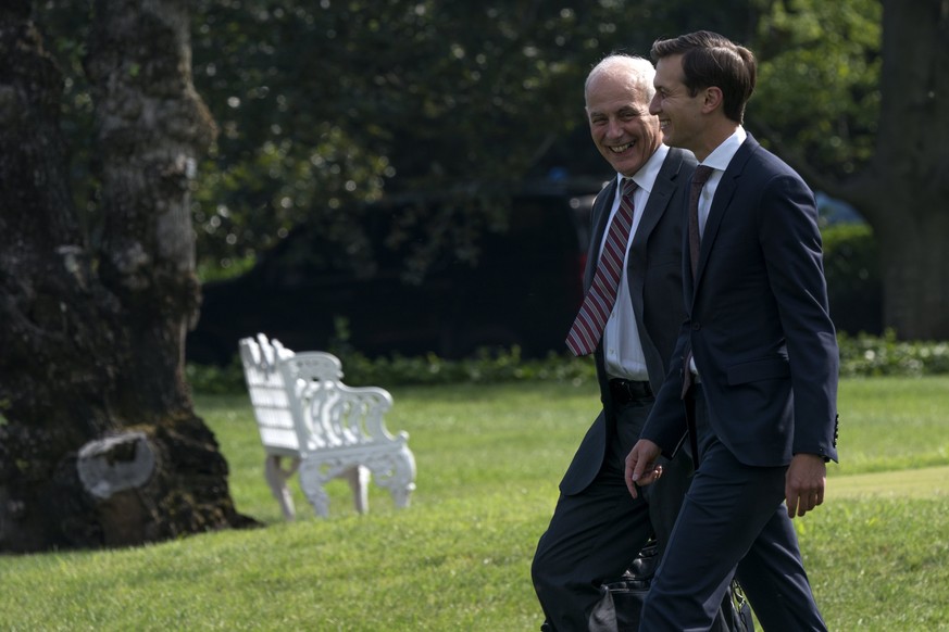 epa06123586 White House Chief of Staff John Kelly (L) talks with senior advisor to President Donald J. Trump Jared Kushner (2-L) as they walk to board Marine One on the South Lawn of the White House i ...