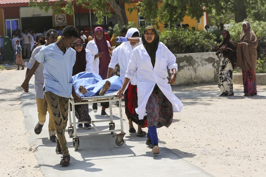 epa07733094 A person who was injured in a blast is carried on a stretcher at Medina hospital in Mogadishu, Somalia, 22 July 2019. Several people are feared dead after a huge explosion at a checkpoint  ...