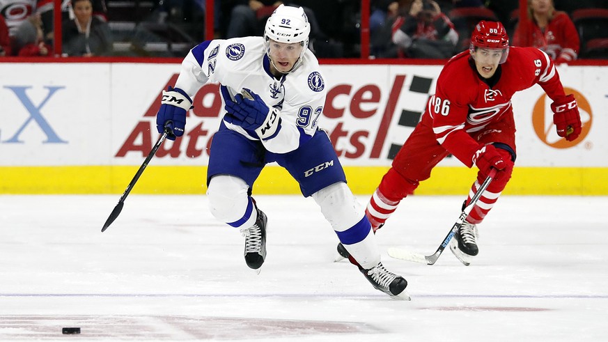 Tampa Bay Lightning&#039;s Joel Vermin (92) takes the puck down the ice after taking it away from Carolina Hurricanes&#039; Teuvo Teravainen (86) during the first period of an NHL hockey game, Sunday, ...