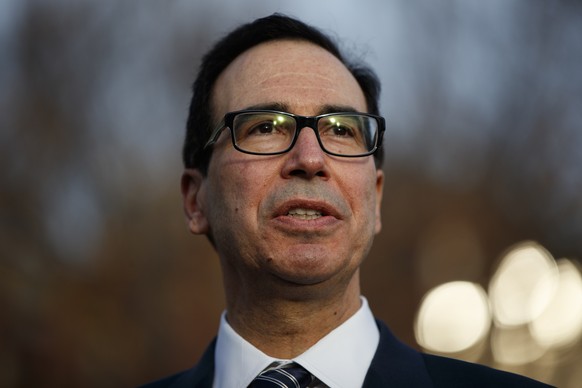 FILE - In this Dec. 3, 2018, file photo, Treasury Secretary Steven Mnuchin talks with reporters at the White House, in Washington. Mnuchin says that the negative market reaction following the Federal  ...