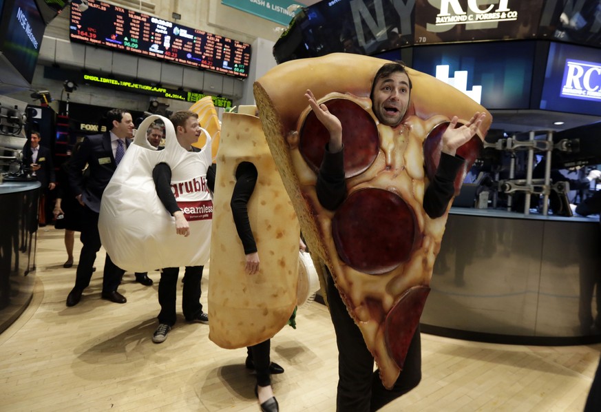 Costume characters representing GrubHub walk the New York Stock Exchange trading floor before the company&#039;s IPO, Friday, April 4, 2014. Investors sent shares of online food ordering service GrubH ...