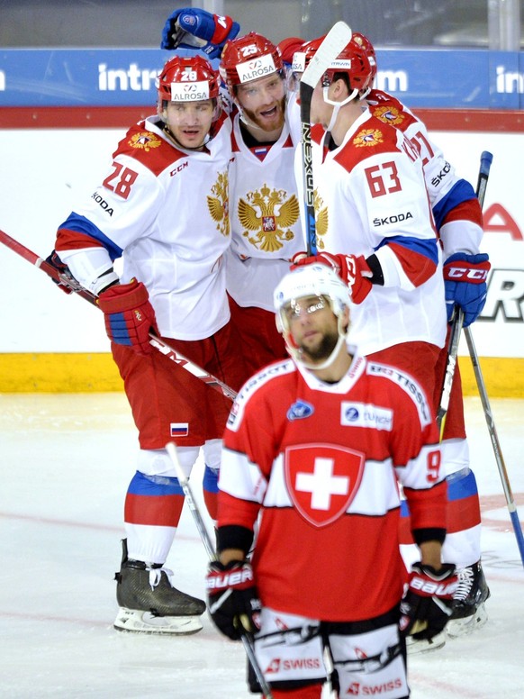 Russia&#039;s Andrei Zubarev, left, Mikhail Grigorenko, second left, Pavel Kraskovski, no. 63, and Sergei Kalinin, rear, celebrate the 2-2 goal during the Ice Hockey Euro Hockey Tour Karjala Cup match ...