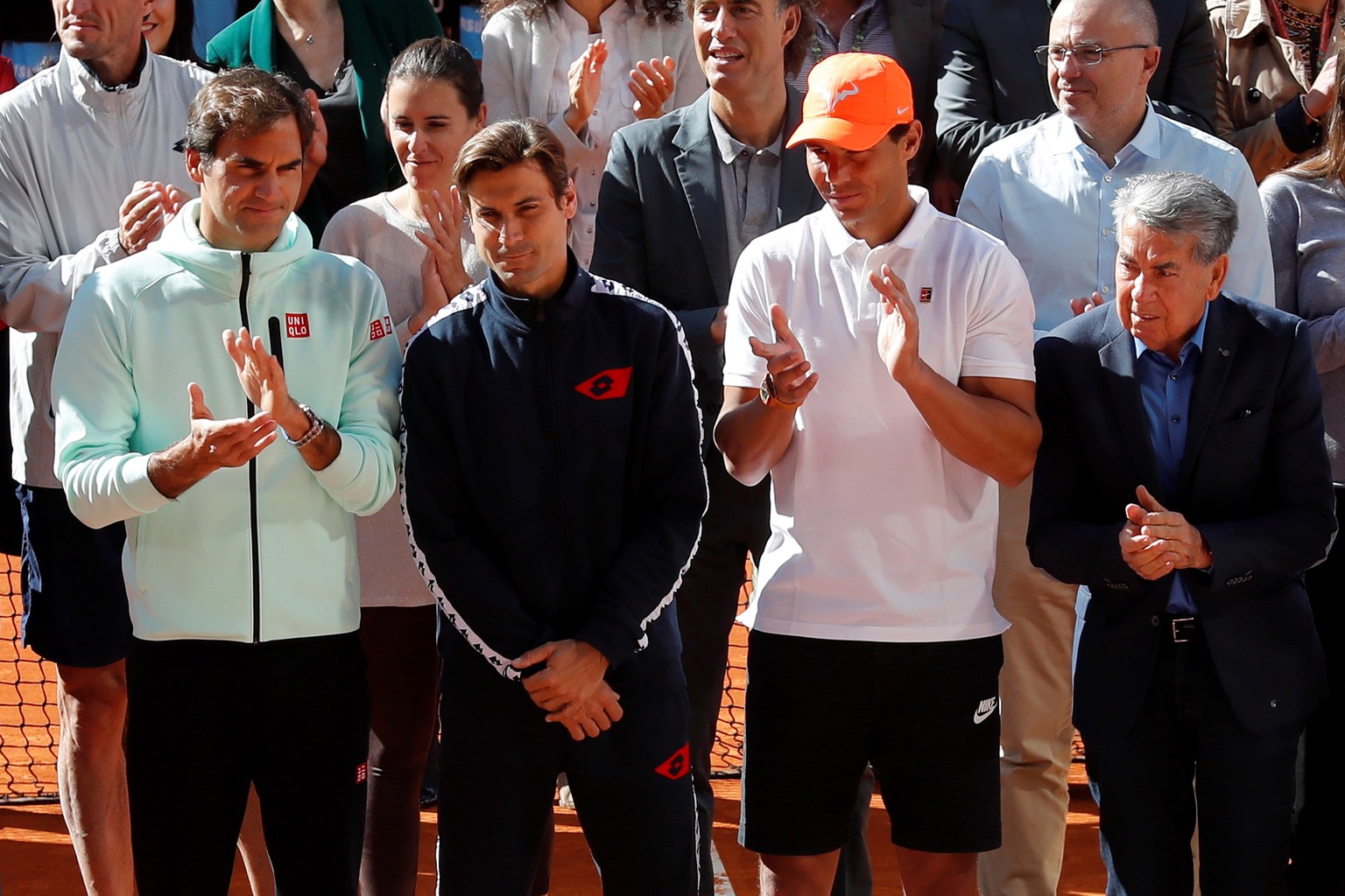 epa07548179 Spanish tennis player David Ferrer (C) is applauded by several comrades, including Swiss Roger Federer (L) and Spaniard Rafael Nadal (2-R), and Spanish tennis legend Manolo Santana (R), du ...