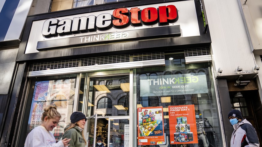 FILE - In this Jan. 28, 2021, file photo, pedestrians pass a GameStop store on 14th Street at Union Square, in the Manhattan borough of New York. The recent GameStop frenzy provided what parents and e ...
