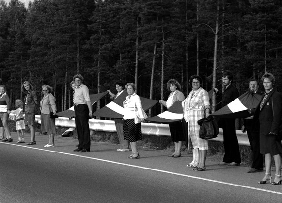 People hold hands and Latvian flags as they participate in a human chain at Baltic Way near Riga August 23, 1989. Runners left Lithuania and Estonia on August 22, 2009, for neighbouring Latvia to star ...
