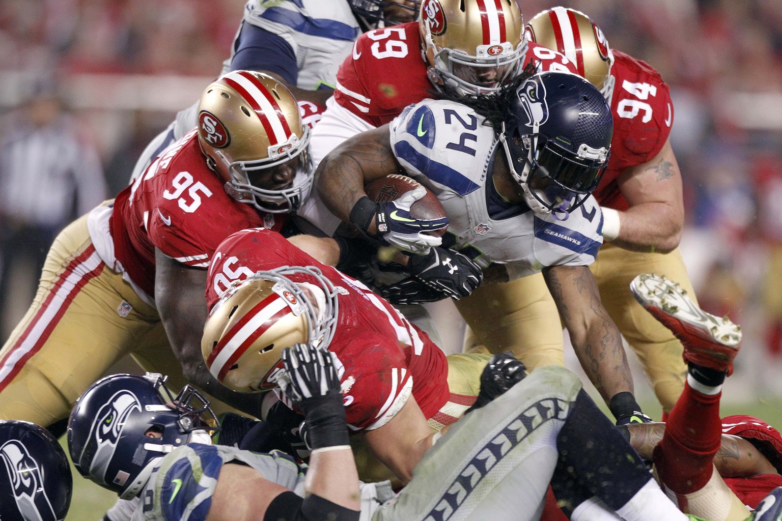 Nov 27, 2014; Santa Clara, CA, USA; Seattle Seahawks running back Marshawn Lynch (24) is tackled by San Francisco 49ers outside linebacker Aaron Lynch (59) in the second quarter at Levi&#039;s Stadium ...