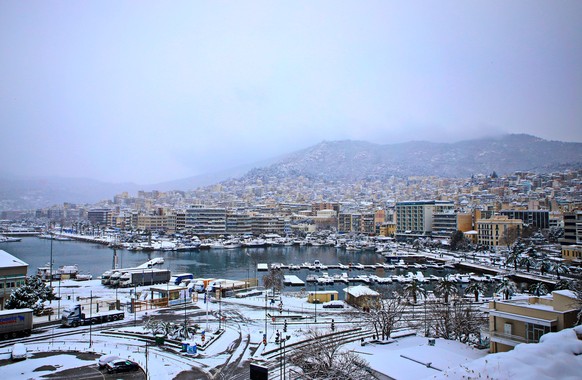 epa09012953 Kavala city is seen covered in snow, northern Greece, 14 February 2021. The first wave of the Medea weather system was fully underway in Greece on 14 February, bringing snow to many parts  ...