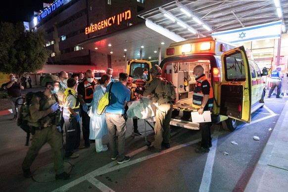epa09168929 Israeli rescuers transport injured Ultra-Orthodox Jews from an event celebrating Lag Ba&#039;Omer to a hospital in Mount Meron, Israel, 30 April 2021. Dozens of people were killed and inju ...