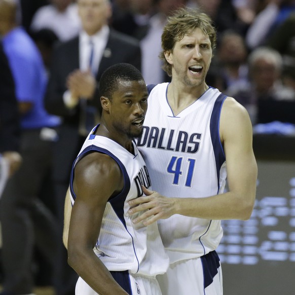 Dallas Mavericks Dirk Nowitzki, right, celebrates with teammate Harrison Barnes as time runs out at the end of their regular-season NBA basketball game against the Phoenix Suns in Mexico City, Thursda ...