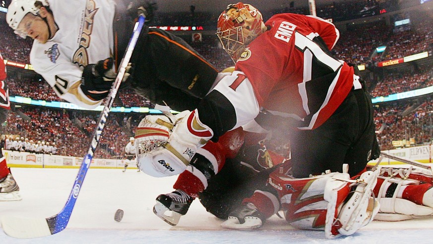 Anaheim Ducks Corey Perry (10) flies over Ottawa Senators goaltender Ray Emery during the first period of Game 4 of the Stanley Cup hockey finals in Ottawa Monday, June 4, 2007. (AP PHOTO/Jim McIsaac, ...