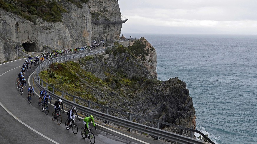 Cyclists ride along the coastline during the Milan-San Remo cycling race, in Sanremo, Italy, Sunday, March 23, 2014. Alexander Kristoff sprinted to victory in the Milan-San Remo classic on Sunday, edg ...